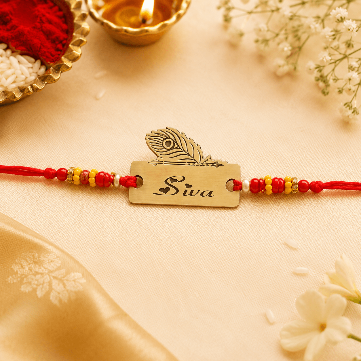 Peacock Feather Name Rakhi with Red & Yellow Beads